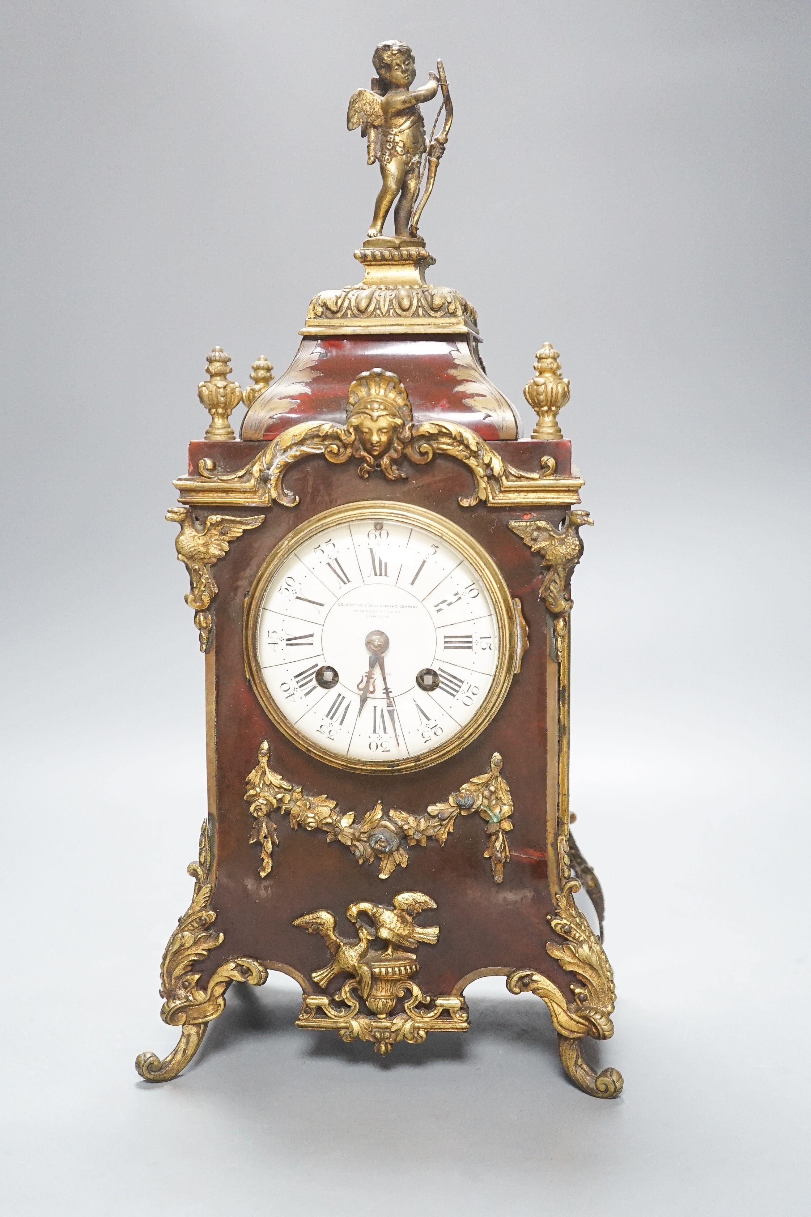 A 19th century French tortoiseshell and gilt metal mounted clock with key and pendulum 40cm